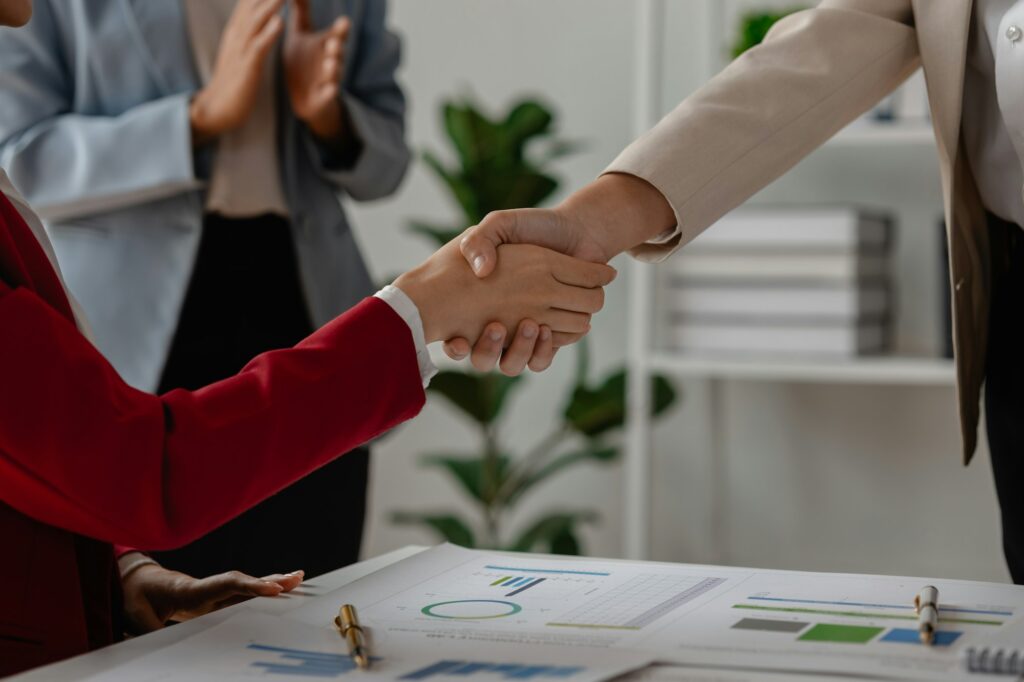 two big companies handshake because they agree on a business deal, businesspeople just signed commit